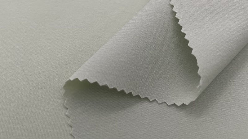 An angler casting a line while wearing a flexible nylon-blend fishing shirt