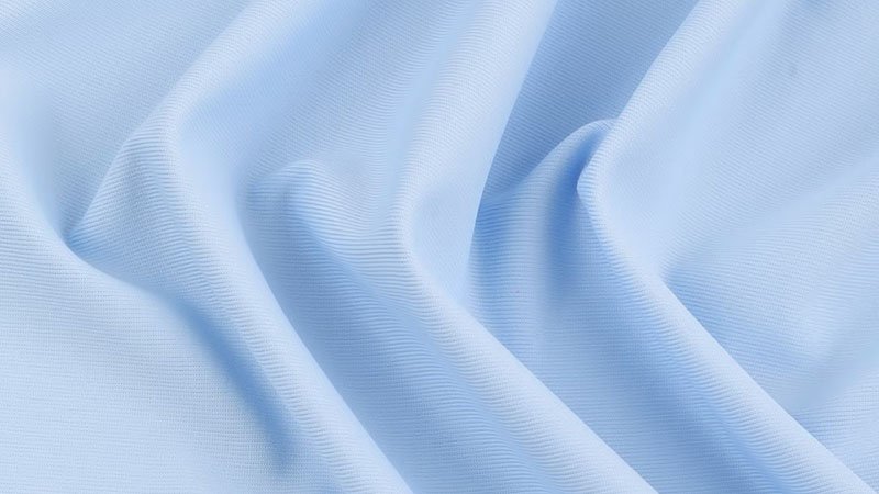 Water splashing off a polyester fishing shirt, showing its quick-dry nature